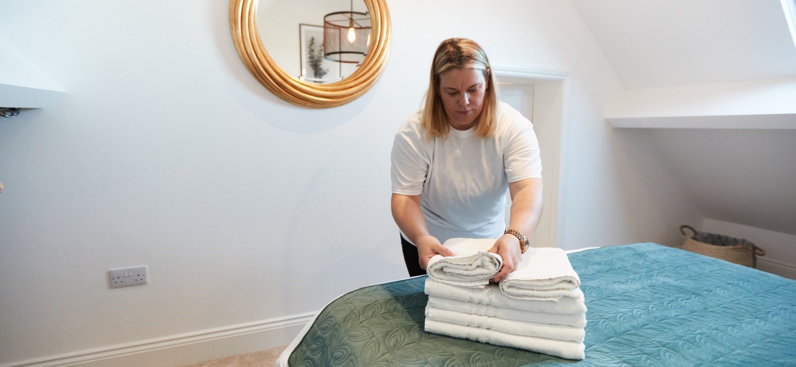 A woman cleaning a bedroomThe Holiday Home Housekeeper