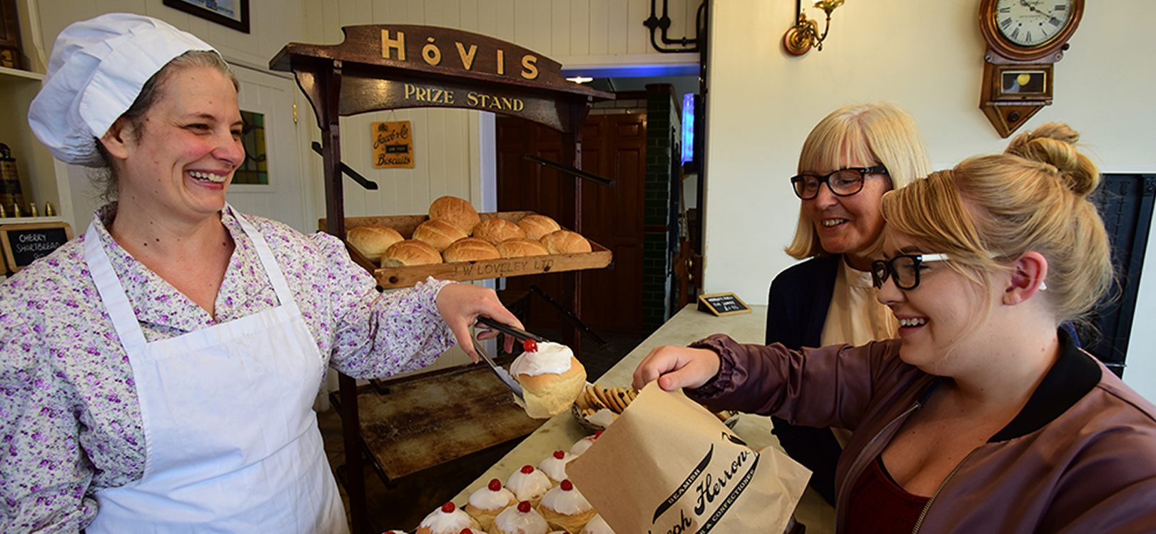 Two people being served at the bakery in Beamish