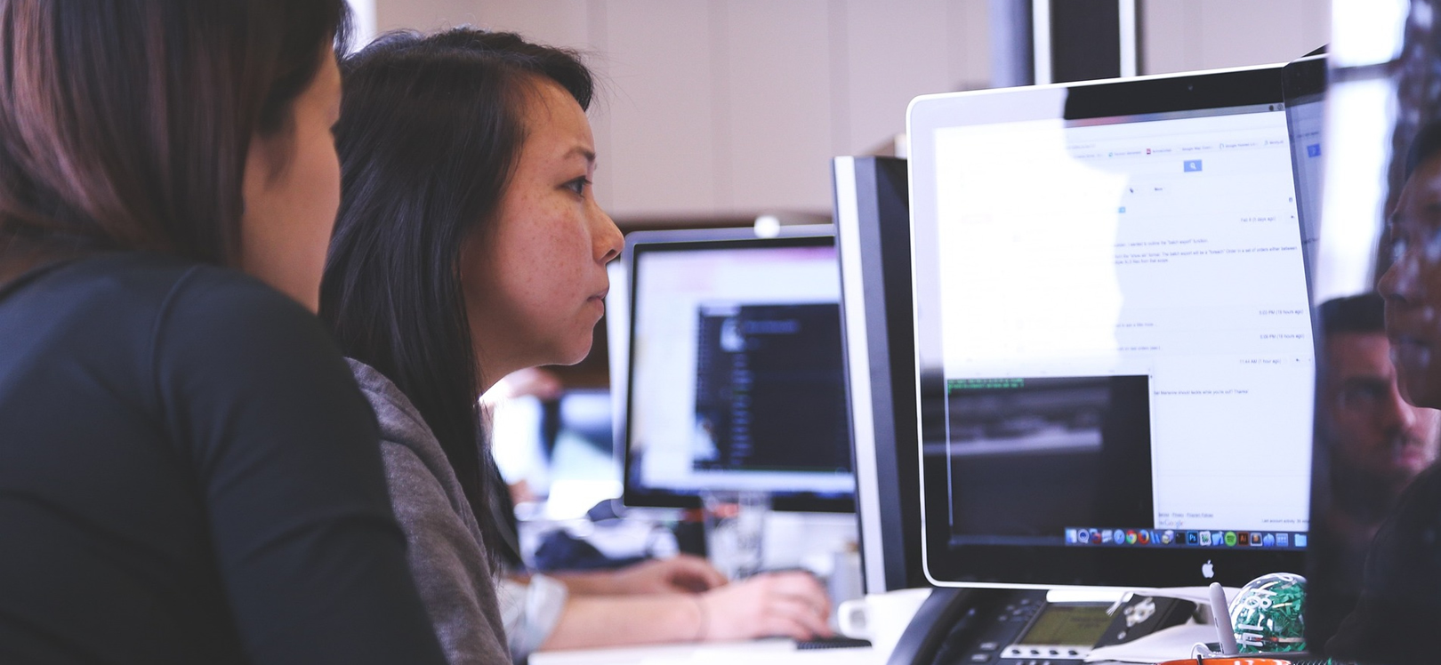 Two woman using a laptop