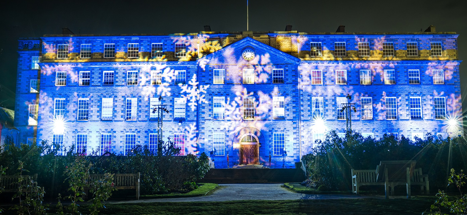 Ushaw building lit with snow flakes