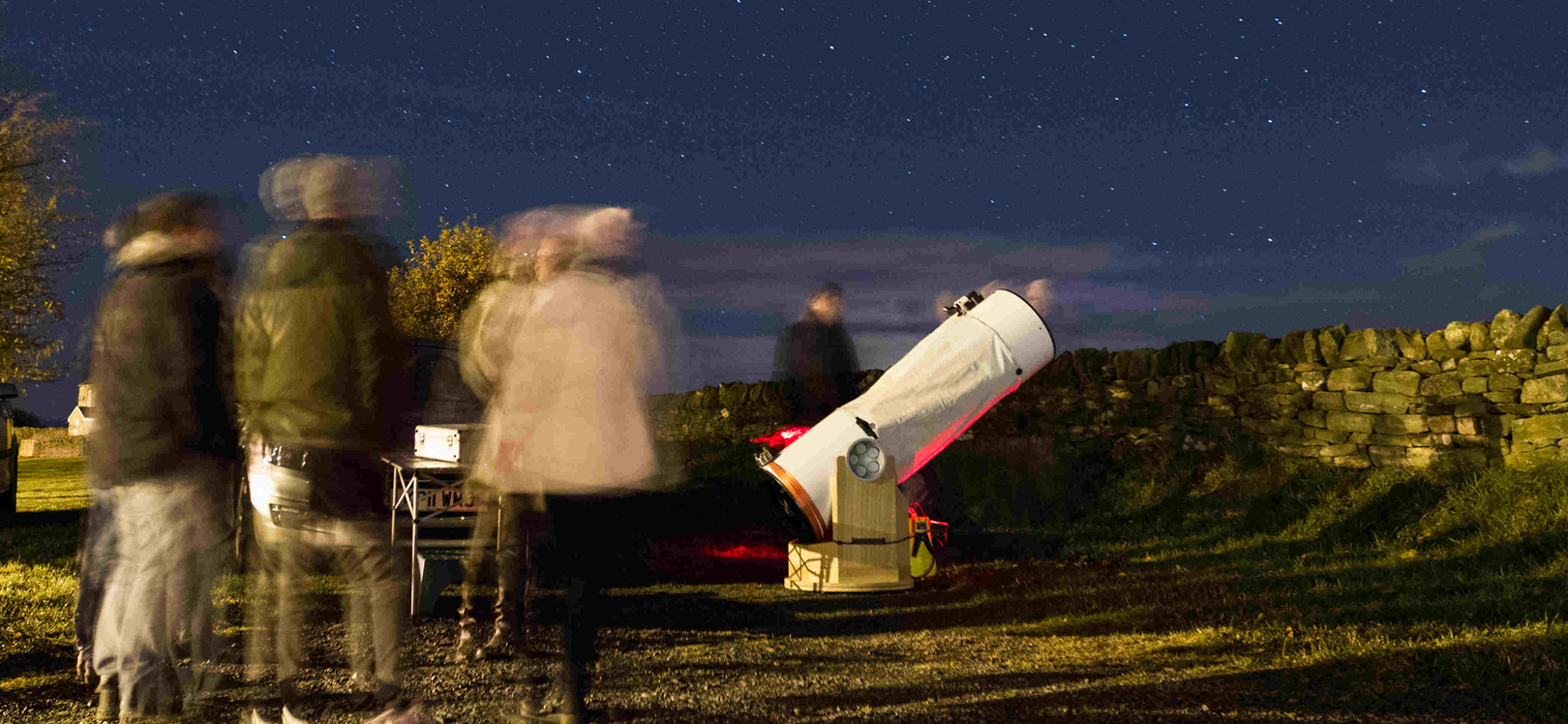 People surrounding a telescope