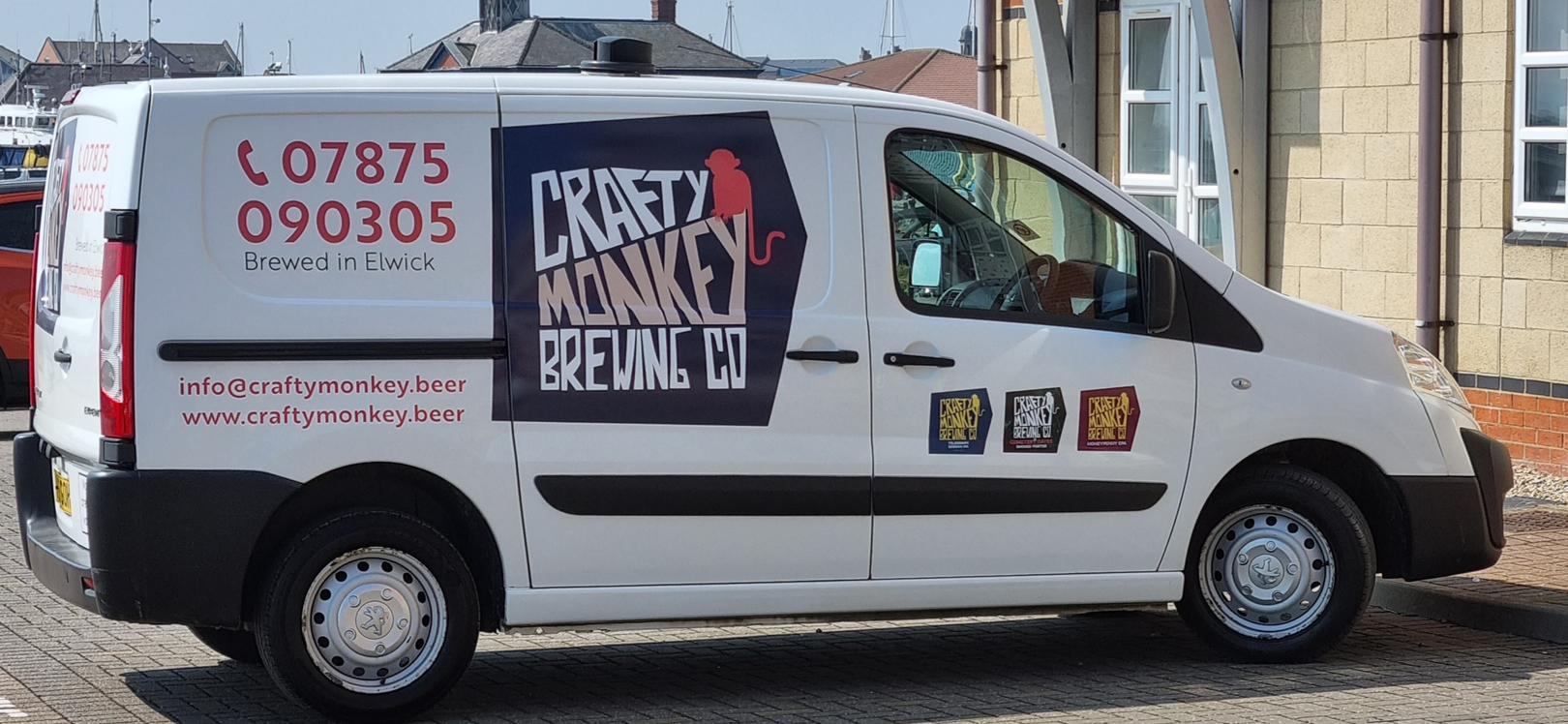 A van with Crafty Monkey Brewery logo on