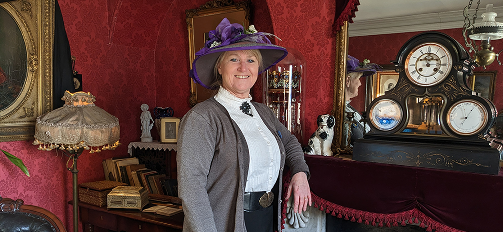 Woman stood next to a fireplace at Beamish