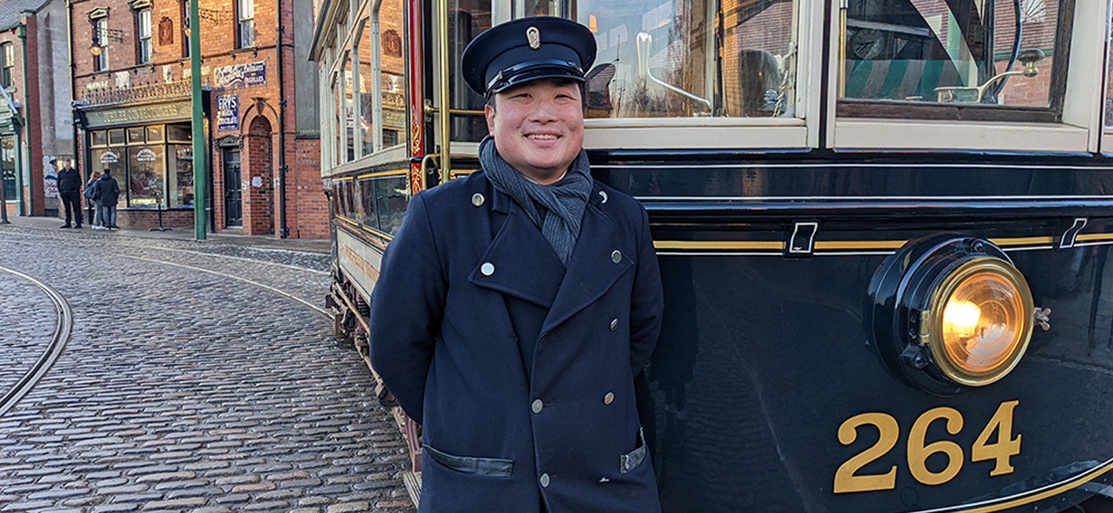 Man stood next to a tram at Beamish Museum