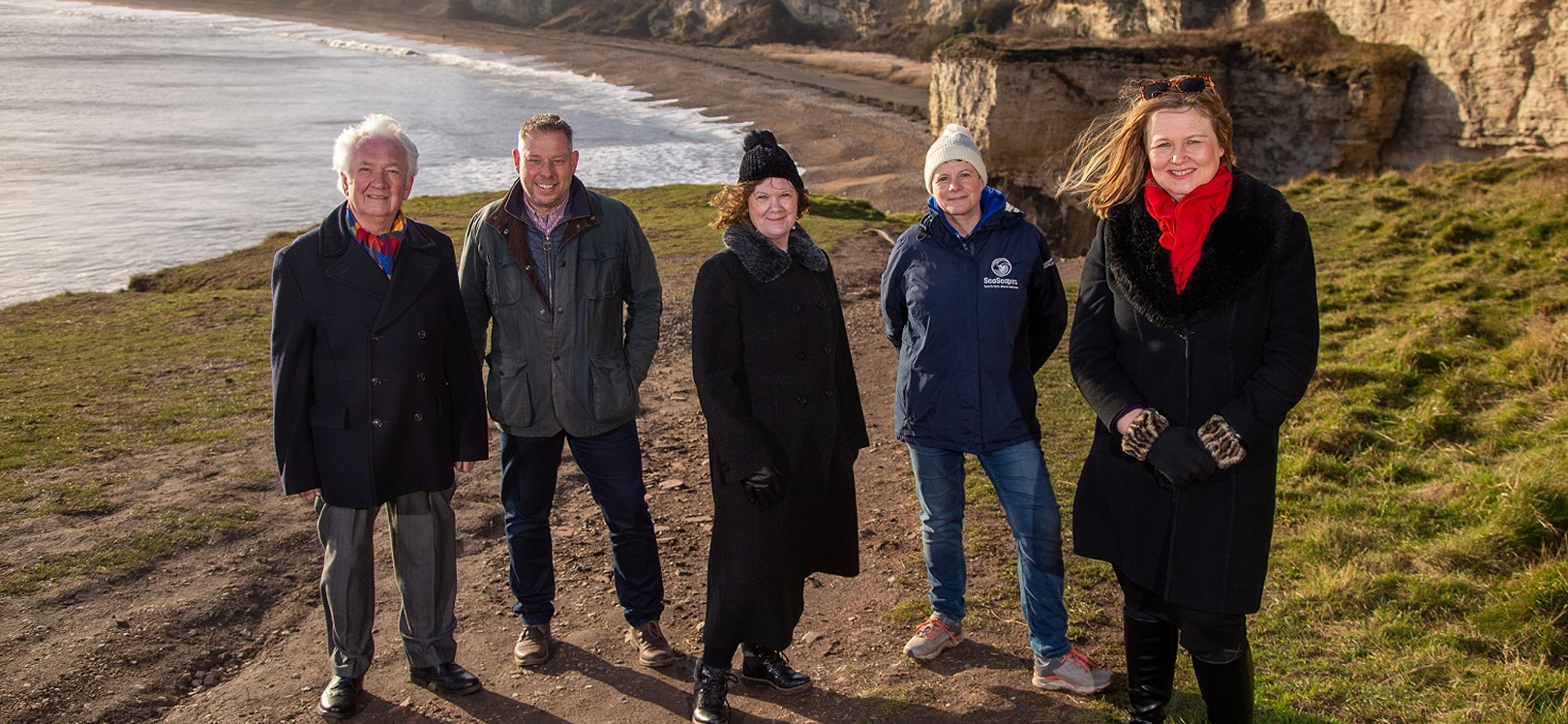 A group of people on top of a beach bank