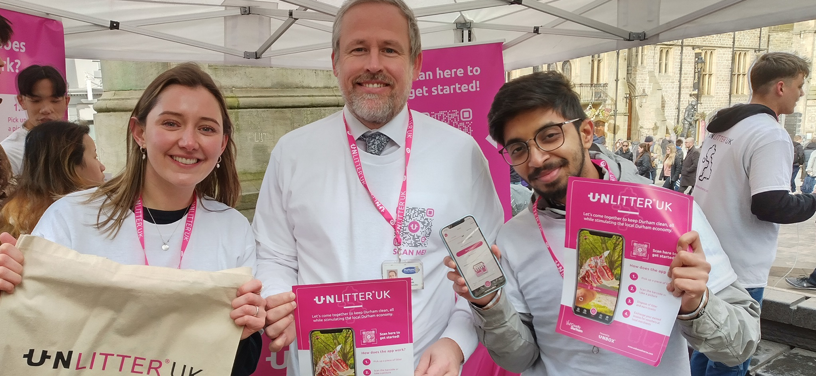 Three people holding unlitter leaflets