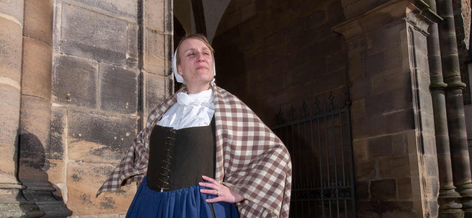 A women in costume outside Auckland Castle