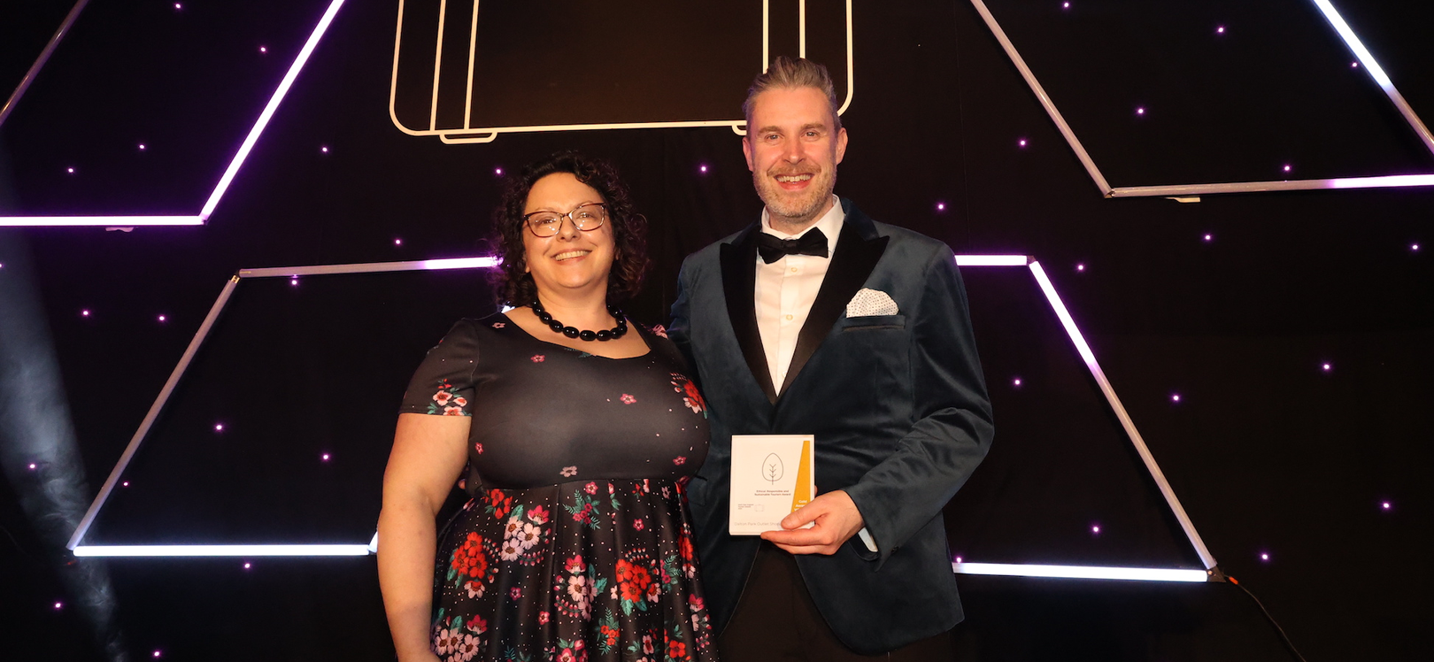 Two people holding an award for Dalton Park