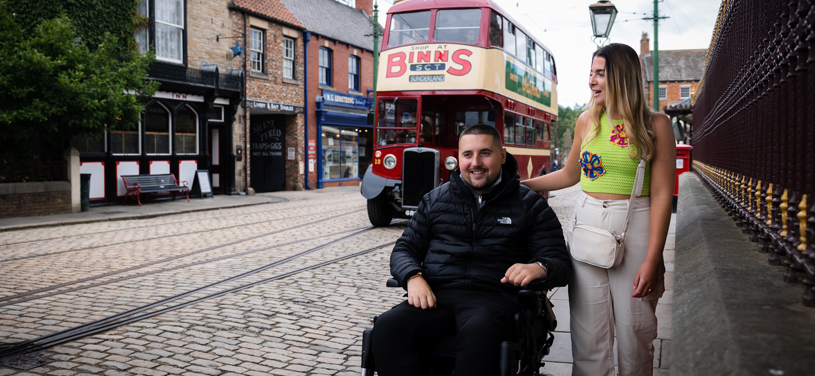 A woman stood next to a man in a wheelchair at Beamish Museum