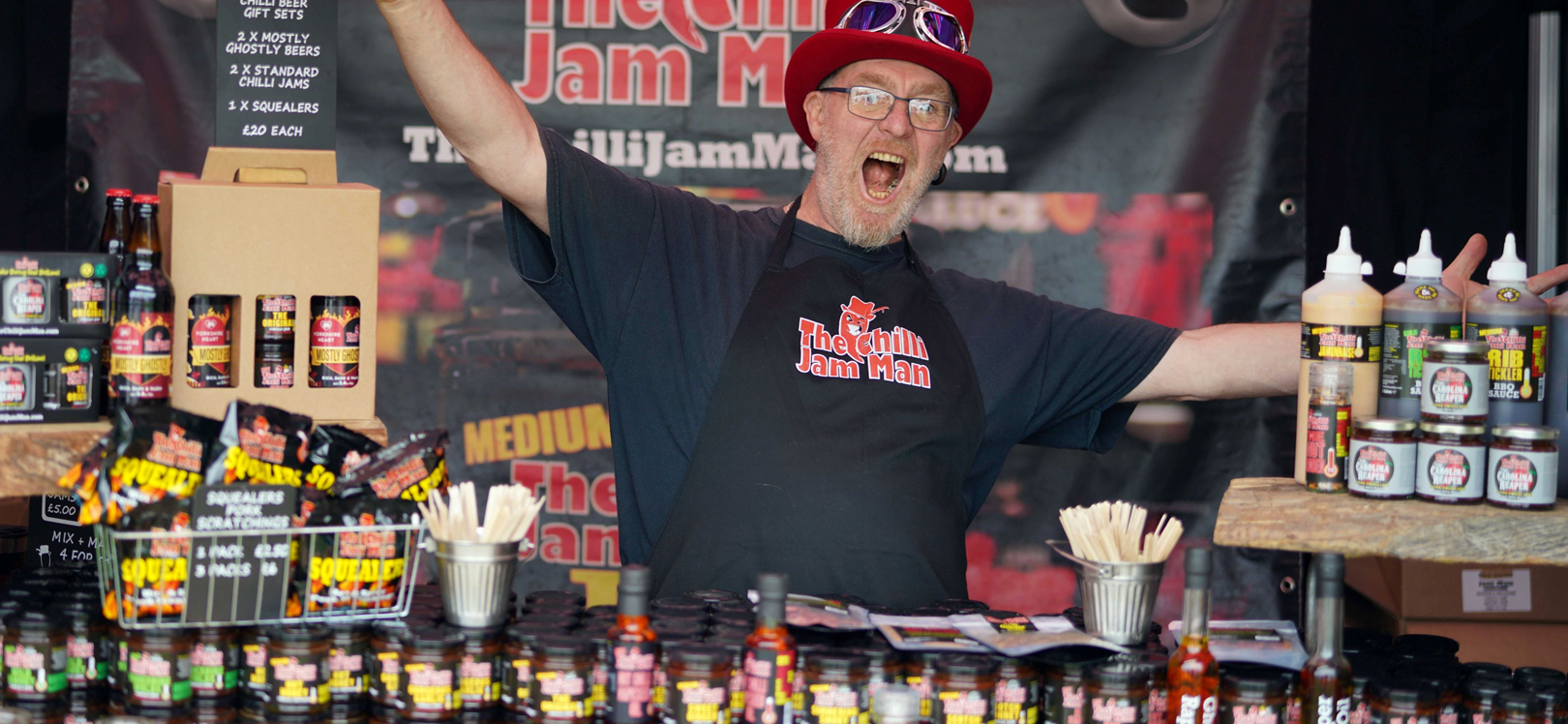 A man cheering at his food stall