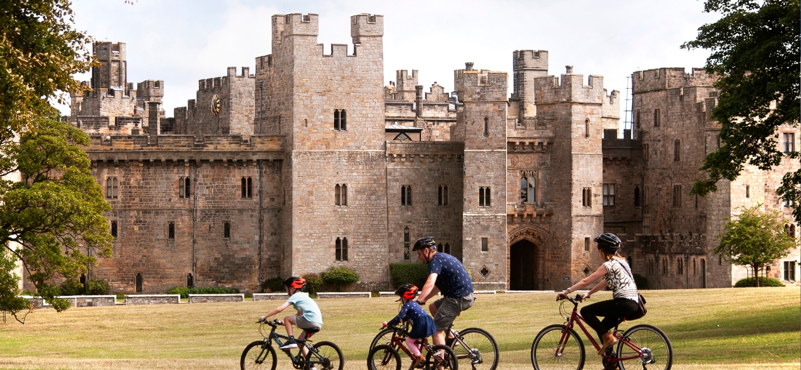 A family cycling at Raby Castle