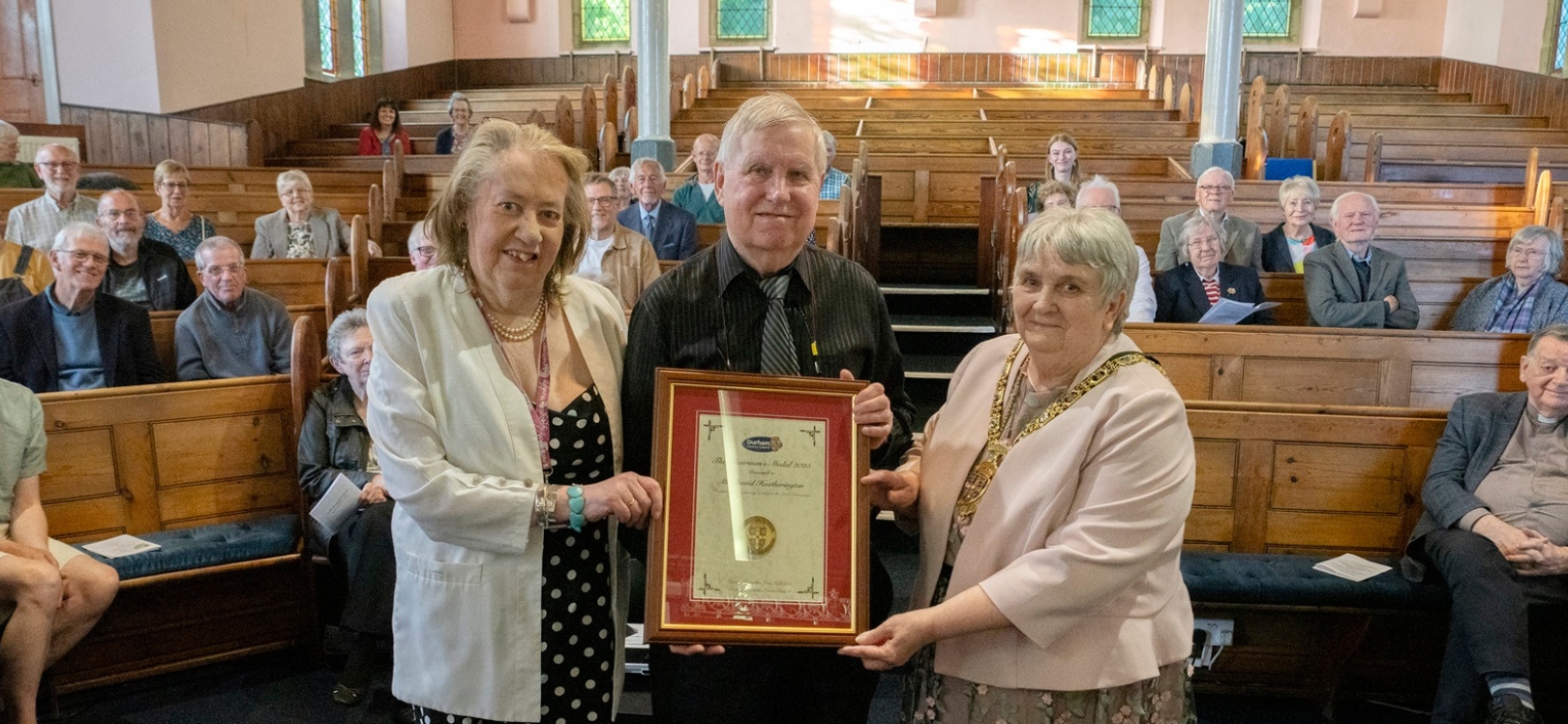 Mr Robert Nicholson (front-left) and outgoing Chair Joan Nicholson (front-right) with volunteers from the Weardale Railway Trust.