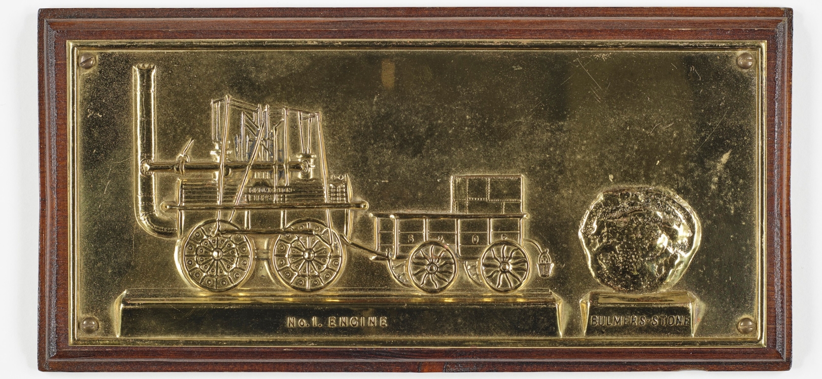A brass plaque featuring an image of Locomotion No. 1 Engine.