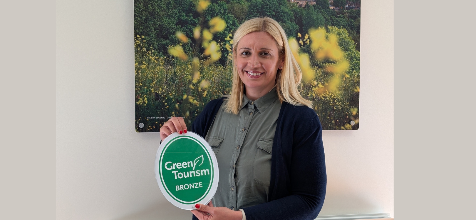 Lucy Wearne holding a Green Tourism award
