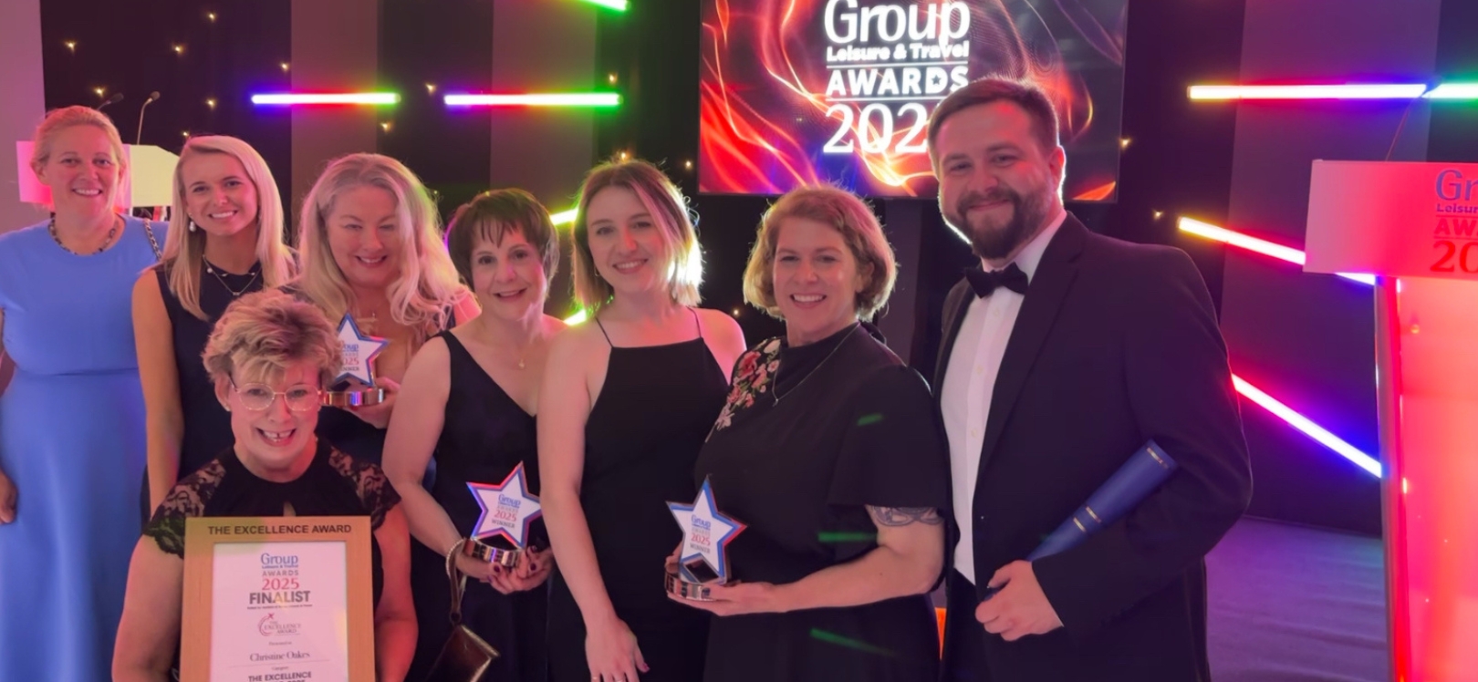 A group of people holding an award