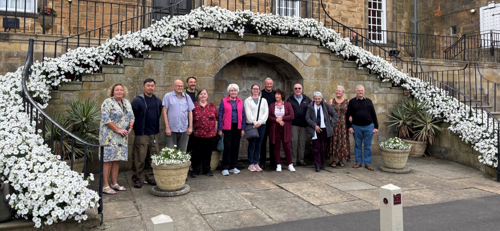 A group of people stood outside of Lumley Castle stairs