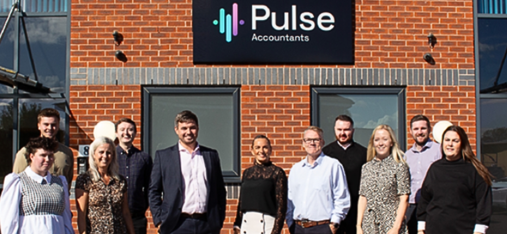 The employees of Pulse stood outside of their building