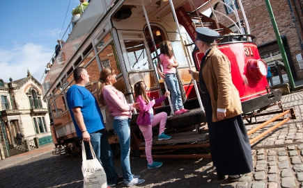 A family getting on a tram at Beamish