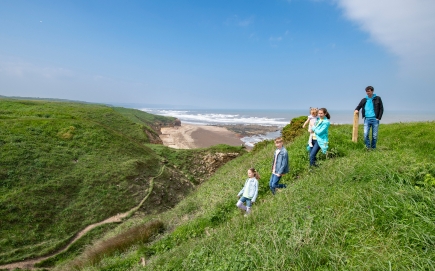 A family walking in the dune on Durham Coast