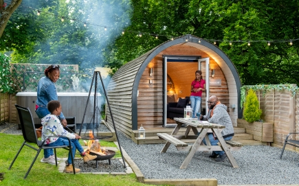A family camping with a shepherds hut, hot tub and camp fire
