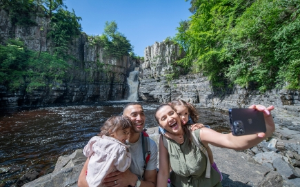 A group of people taking a selfie at High Force