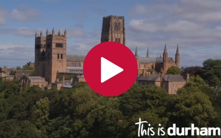 Durham Cathedral with a play button on the top