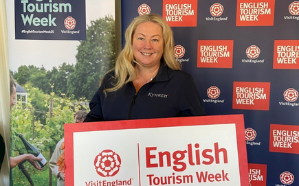 Wendy Wilshere holding an English Tourism Week sign